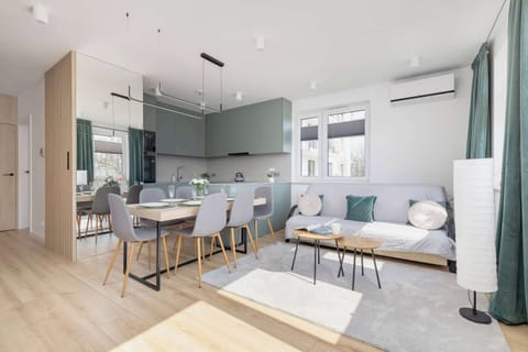 A cozy living room with a stylish sofa, coffee table, and large windows providing natural light. A perfect spot to relax and unwind with a modern aesthetic.