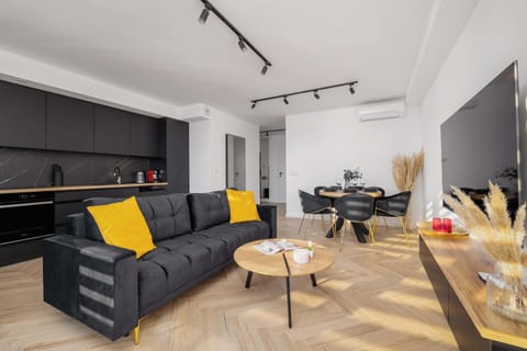 Relax in the stylish living room with a comfortable sofa and modern decor.