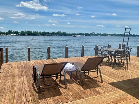 Large Lounge Deck overlooking False River. Chaise Lounge Chairs, outdoor seating, and table.