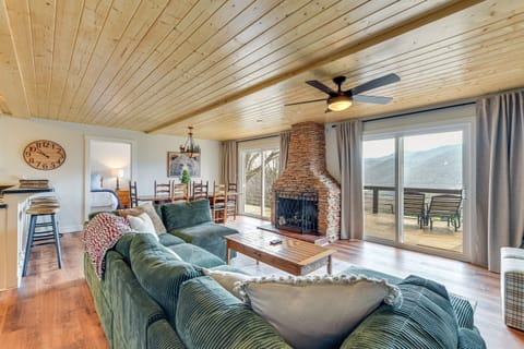 Living Room: Spacious room with stunning mountain views and a welcoming stone fireplace!