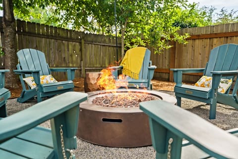 Backyard hang - Propane fire pit, 6 Adirondack chairs & overhead string lights.