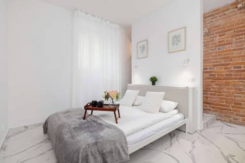 A bright interior with a brick wall and subtle decor creates a cozy place to relax.