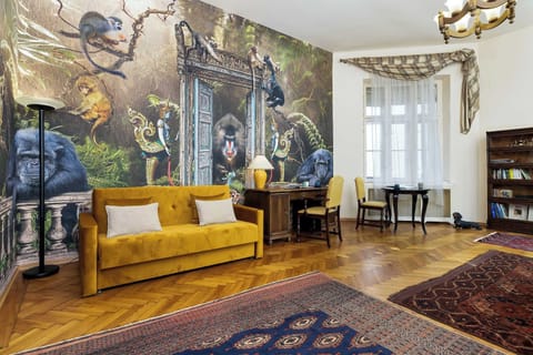 Traditional and elegant bedroom with double sofa bed, desk for comfortable remote work, and dining table.