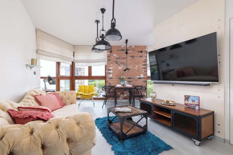 A cosy living area with soft sofas and a large TV invites you to unwind after a busy day.