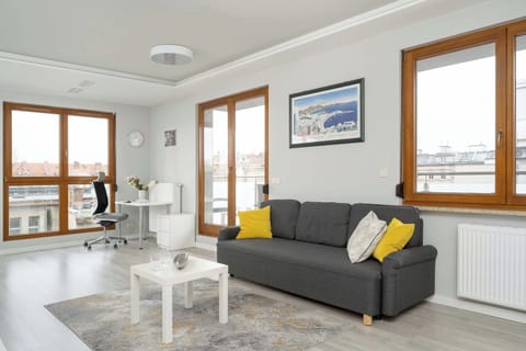 Relax in the stylish living room with a comfortable sofa and modern decor.
