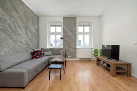 A spacious living room with a corner sofa and TV, designed in a modern style.