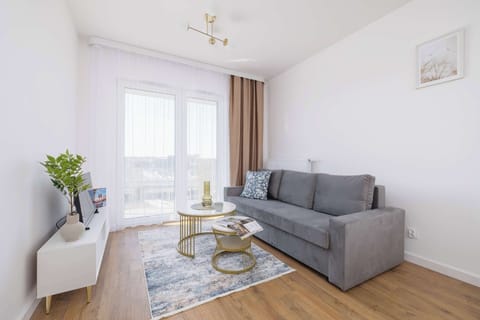 Relax in the stylish living room with a comfortable sofa and modern decor.