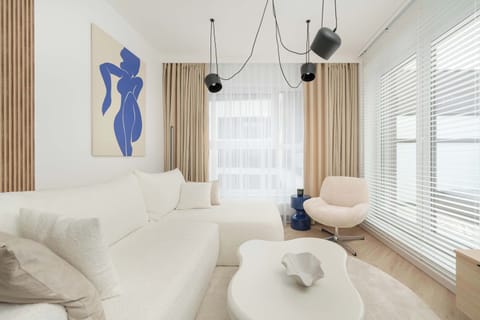 Elegant and bright room with a sofa bed, coffee table and TV.