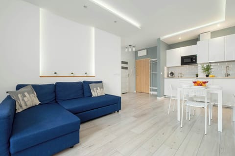 A spacious living area with a comfy sofa and bright dining zone invites relaxation and shared meals.