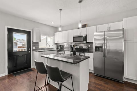 The sleek, open kitchen offers ample space & all the comforts of home