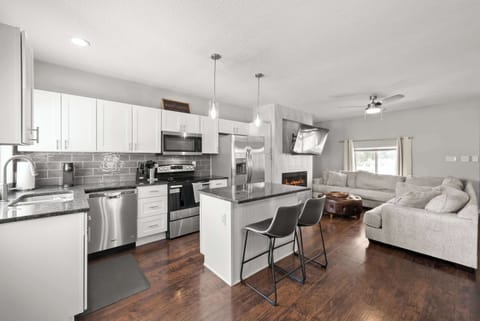 The sleek, open kitchen offers ample space & all the comforts of home