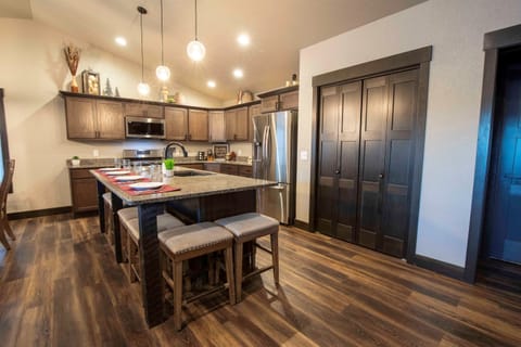 Picture yourself preparing meals in the sleek kitchen at "On The Rocks," surrounded by stainless steel appliances and a spacious granite island with bar stools.