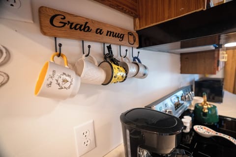 Whip up something sweet! This cheerful kitchen has all the essentials—plus bee-utiful coffee mugs and a deck just outside the door.