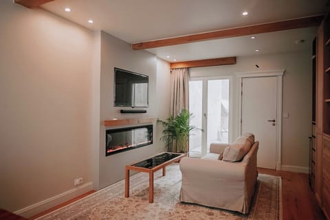 Suite, City View | Living area | 65-inch Smart TV with cable channels, fireplace