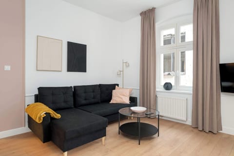 Living room with a comfortable sofa and TV. 
