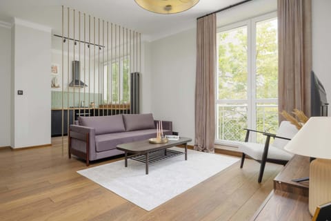 Relax in the stylish living room with a comfortable sofa and modern decor.