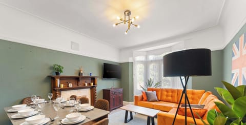 A stylish living room featuring a bold blend of green and violet tones, creating a vibrant and unique atmosphere. The space is designed to feel both modern and inviting—perfect for relaxing, socializing, or unwinding after a long day.