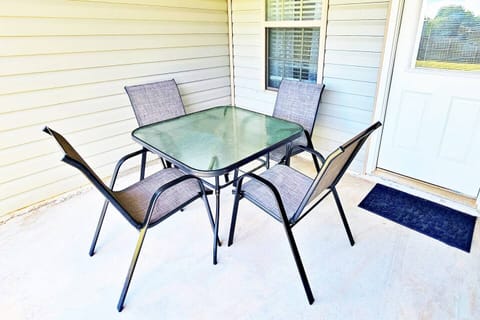 It is located right off the main room in the back. Perfect for 4 to enjoy at sunset or sunrise. Fenced-in backyard for privacy.