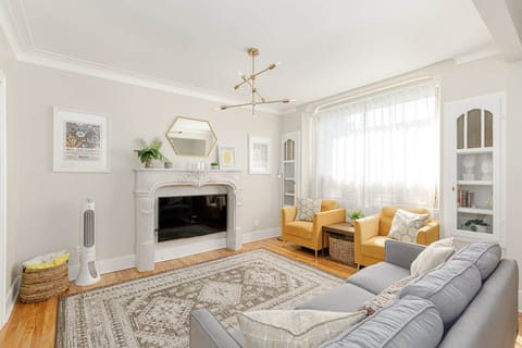 Large smart TV mounted under the faux fireplace. 