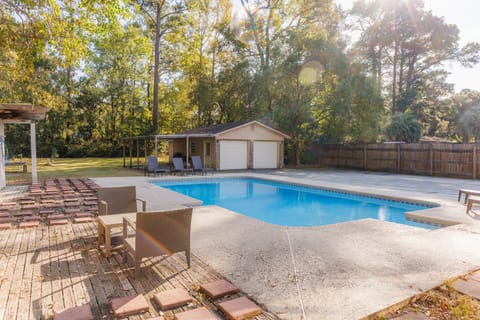 A quiet poolside setting surrounded by trees for a peaceful afternoon.