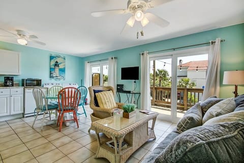 Open-concept living and dining space with beach-inspired color palette.
