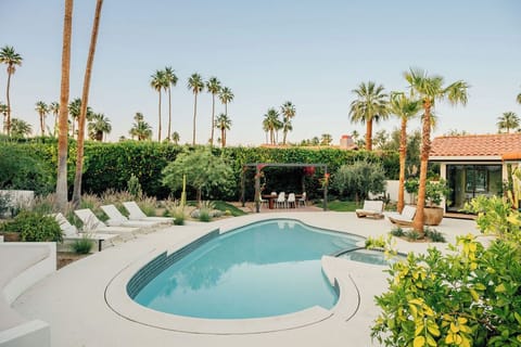 elax beside the resort-style pool and spa surrounded by lush landscaping, swaying palms, and beautiful mountain views.