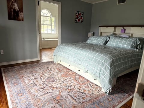 Quiet bedroom with comfortable sleeping space and natural light.