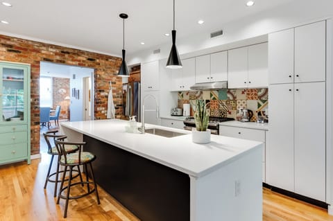 Kitchen: Stylish design with vibrant backsplash and ample seating for culinary adventures!