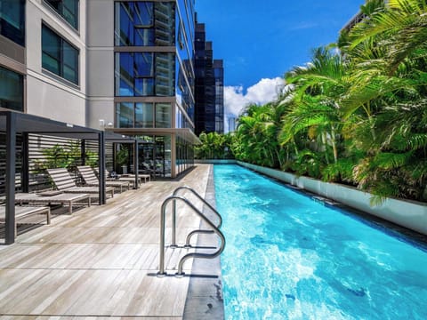 Lap Pool - Wake up to resort vibes at Sky Ala Moana’s lap pool, where a long turquoise lane lined with palms invites morning swims and sunny relaxation. Enjoy free assigned parking, in-unit laundry, and a short walk to Waikiki Beach. Shared with other residents