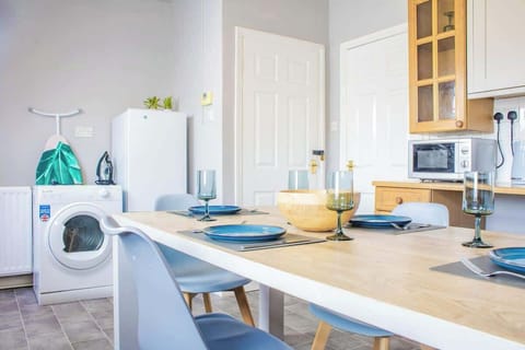 An elegant dining area with a stylish table, comfortable chairs, and ambient lighting, perfect for meals and gatherings.