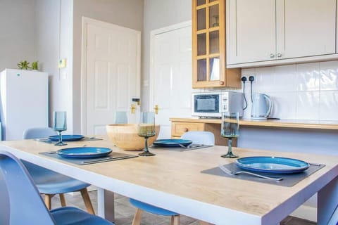 An elegant dining area with a stylish table, comfortable chairs, and ambient lighting, perfect for meals and gatherings.