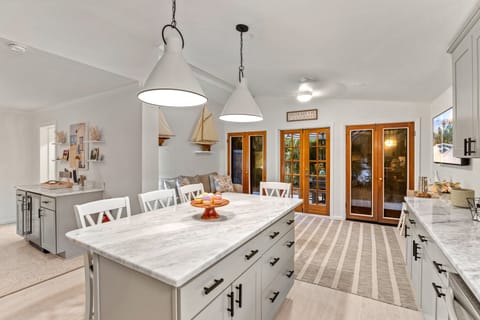 From the kitchen, look out to the den bathed in soft evening light—a seamless flow of comfort, perfect for late-night lounging.