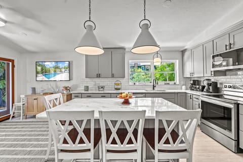 Gather around the granite island for morning coffee or casual bites—this breakfast bar seats four in the heart of the home.