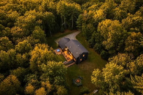Slip into the hot tub on the back deck or gather around the stone fire pit tucked in the yard, both lit up and ready once the sun goes down. Tall trees surround the whole property for total privacy.