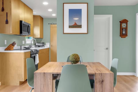 Dining table, with kitchen and bath beyond