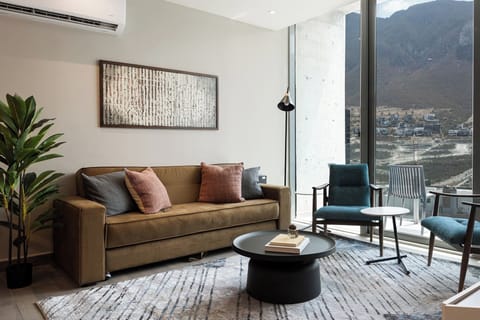 Relax in a living room with mountain views, the perfect spot to gather around!