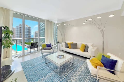 Relax in the cozy living room with stunning views and a smart TV, plush seating, and custom lighting, perfect for winding down or binge-watching.