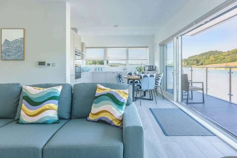 The open-plan kitchen, dining, and living area creates a wonderful sense of space and light - perfect for relaxing, entertaining, or simply enjoying time together. 