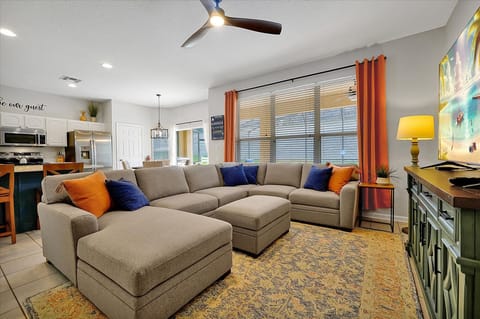 Family Room with comfy couch and 70" TV with Cable