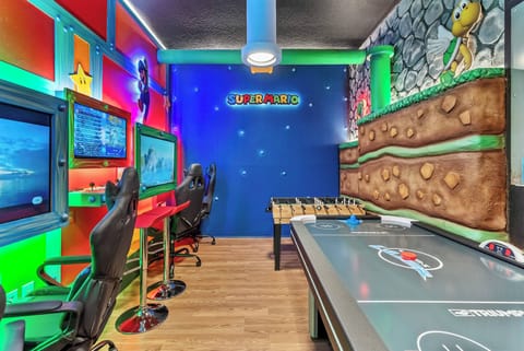 Experience a vibrant gaming paradise filled with colorful murals and playful decor. With a variety of gaming stations and a foosball table, it's the perfect spot for friends and family to share fun and excitement together.