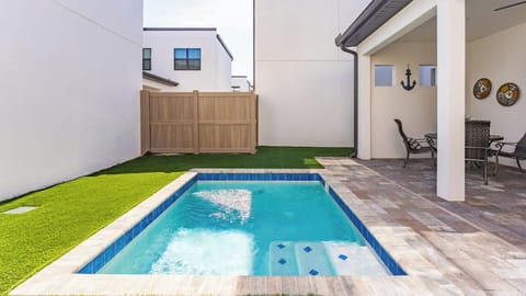 Private pool area with covered patio and outdoor seating for relaxation.