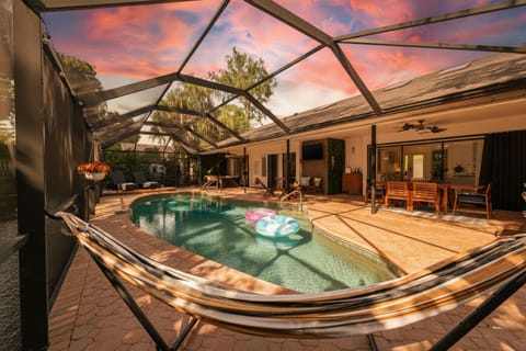 Sun-soaked private pool with hammock, dining area & flamingo float – your outdoor paradise awaits!