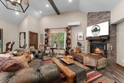 Living Area with Streaming Capable TV, Plush Furniture, Fold-Out Ottoman, Seasonal Fireplace, Deck Access