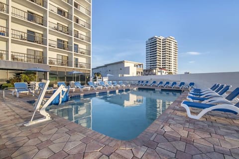 Unwind with plenty of loungers beside the bright, inviting pool.