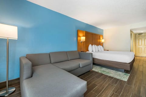 Relax in a comfortable suite with sofa and inviting bed.