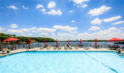Swim and unwind by the seasonal community pool, where breathtaking lake views and sunny vibes