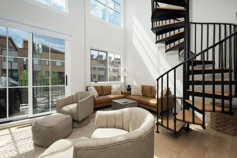 Relax in your bright living space with stylish curved seating and a striking spiral staircase leading to your private upper level.