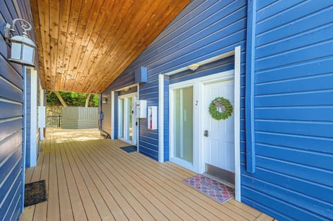 Welcoming entrance with a cozy wooden deck and a festive green wreath on the door. Your charming mountain escape begins here!