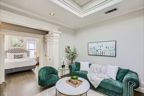 Relax on the comfy green couch in this bright, cheerful living room.