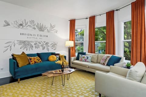 Spacious, cozy, and inviting — unwind in the living room featuring a large Smart TV, plush seating, and warm touches that make you feel right at home.